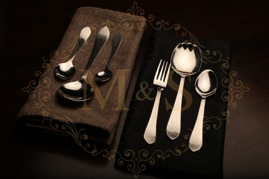 Complete aura essential polka cutlery set placed on black and brown cloth.