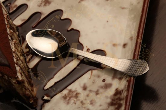Dessert spoon with chocolate dessert.