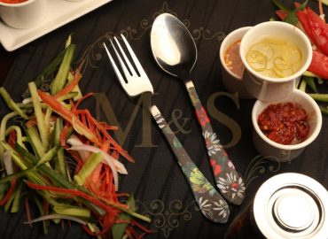 Fork and Tablespoon with vegetables on the left and sauces on right.