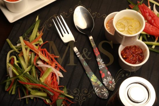 Fork and Tablespoon with vegetables on the left and sauces on right.