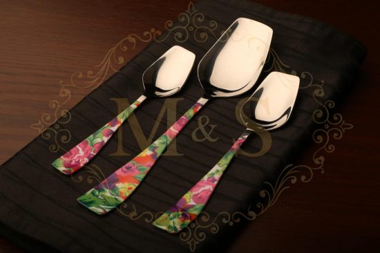 Tea spoon,serving spoon and table spoon placed on the black cloth.