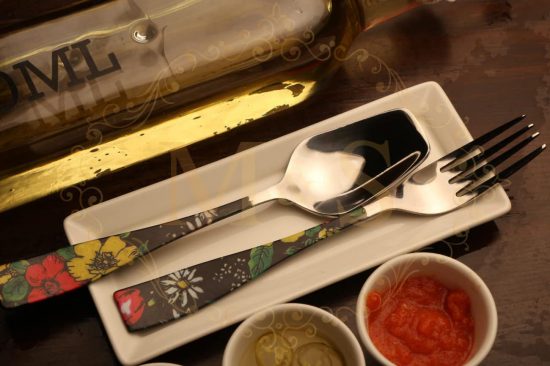 Table spoon and fork placed on tray.