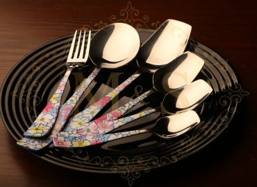 Cutlery set on the black plate.
