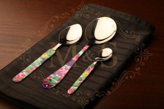 Tablespoon,serving spoon and dessert spoon placed on brown cloth.