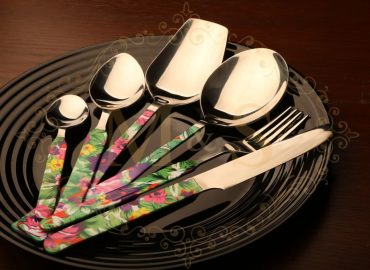 Complete elite ortho bloom cutlery set placed on black plate.