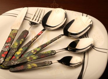 Complete elite ortho floral cutlery set placed on white plate.