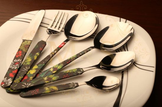 Complete elite ortho floral cutlery set placed on white plate.