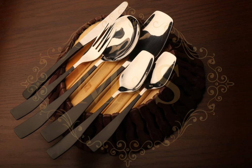 Black themed vintage spoons, forks and knives